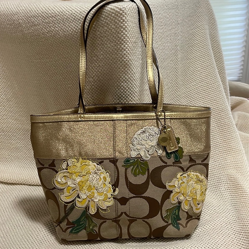 Oh, this is a cute one! Signature Coach print with appliqué flowers.